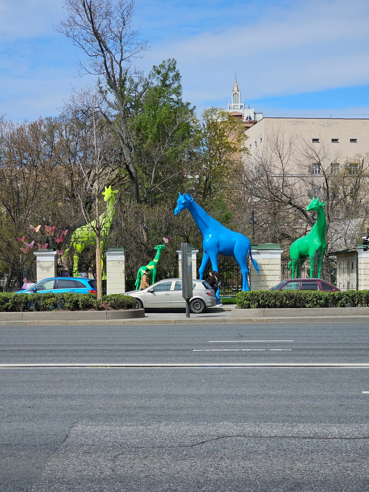 Moscow street scenes feature Stalinist buildings and decorative giraffes