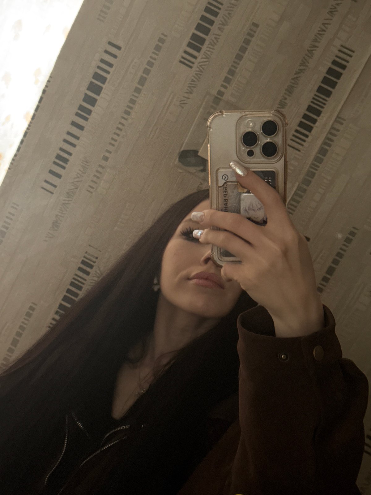 Person takes mirror selfies in Izhevsk indoor setting