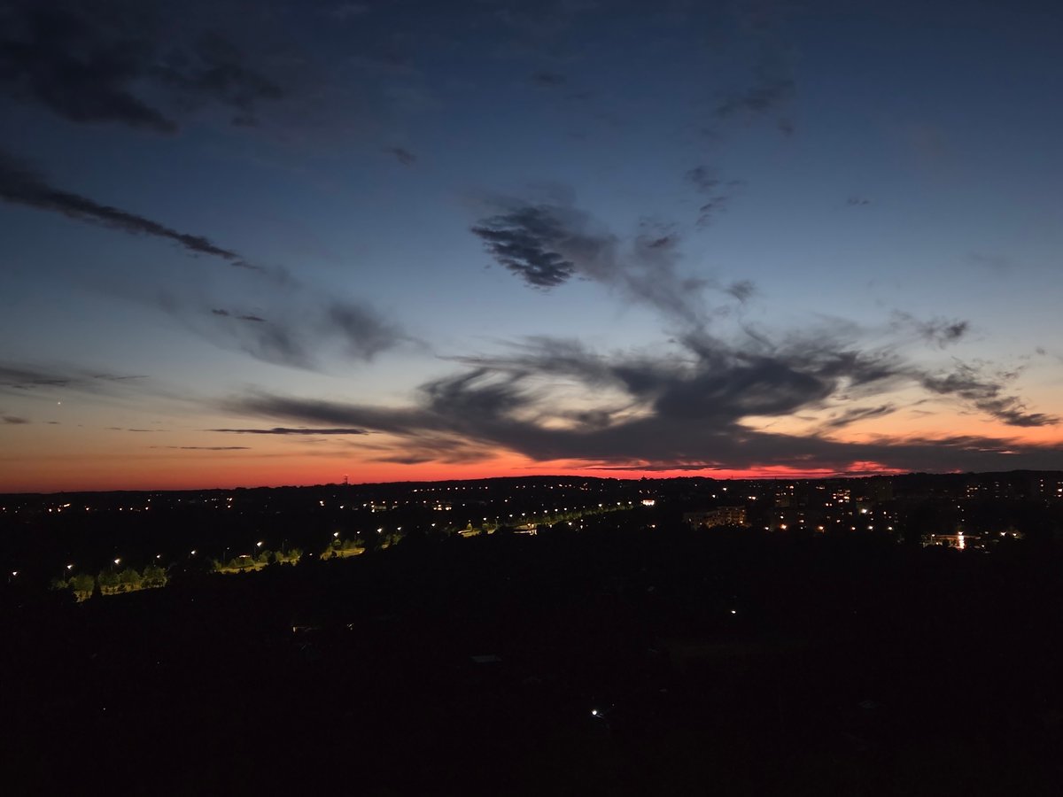 Szczecin skyline at dusk, city lights emerging