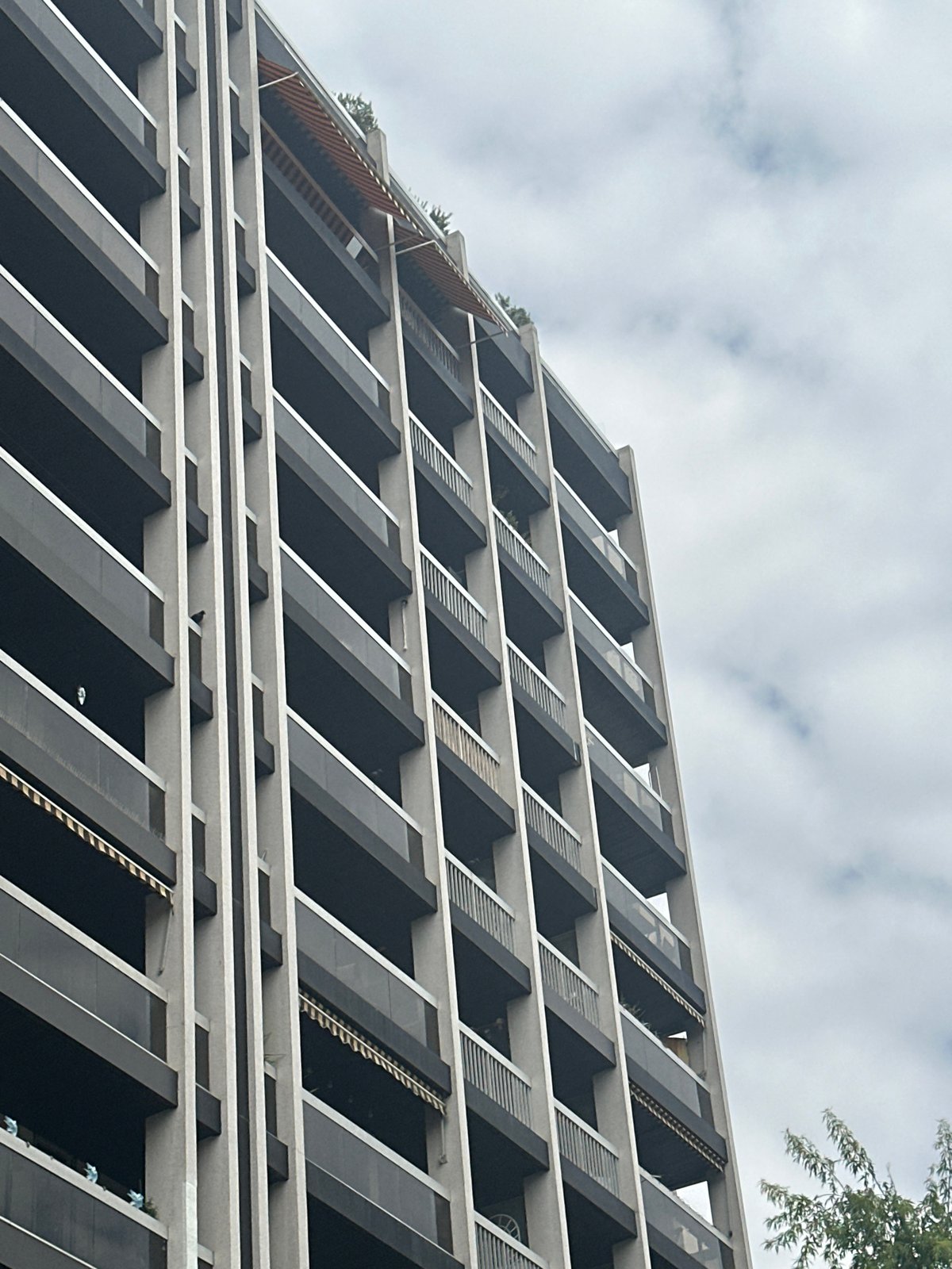 Modern Paris residential building with dark balconies and silver railings