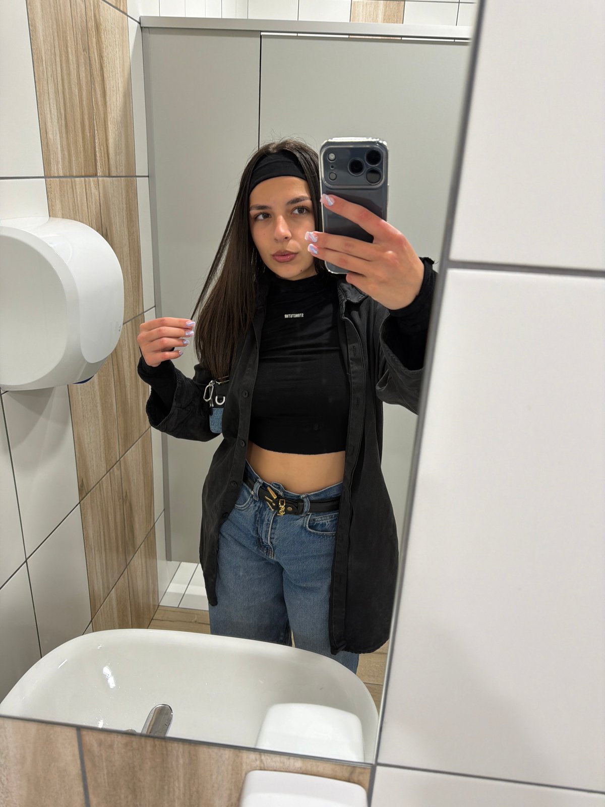 Woman takes bathroom mirror selfies in Sofia