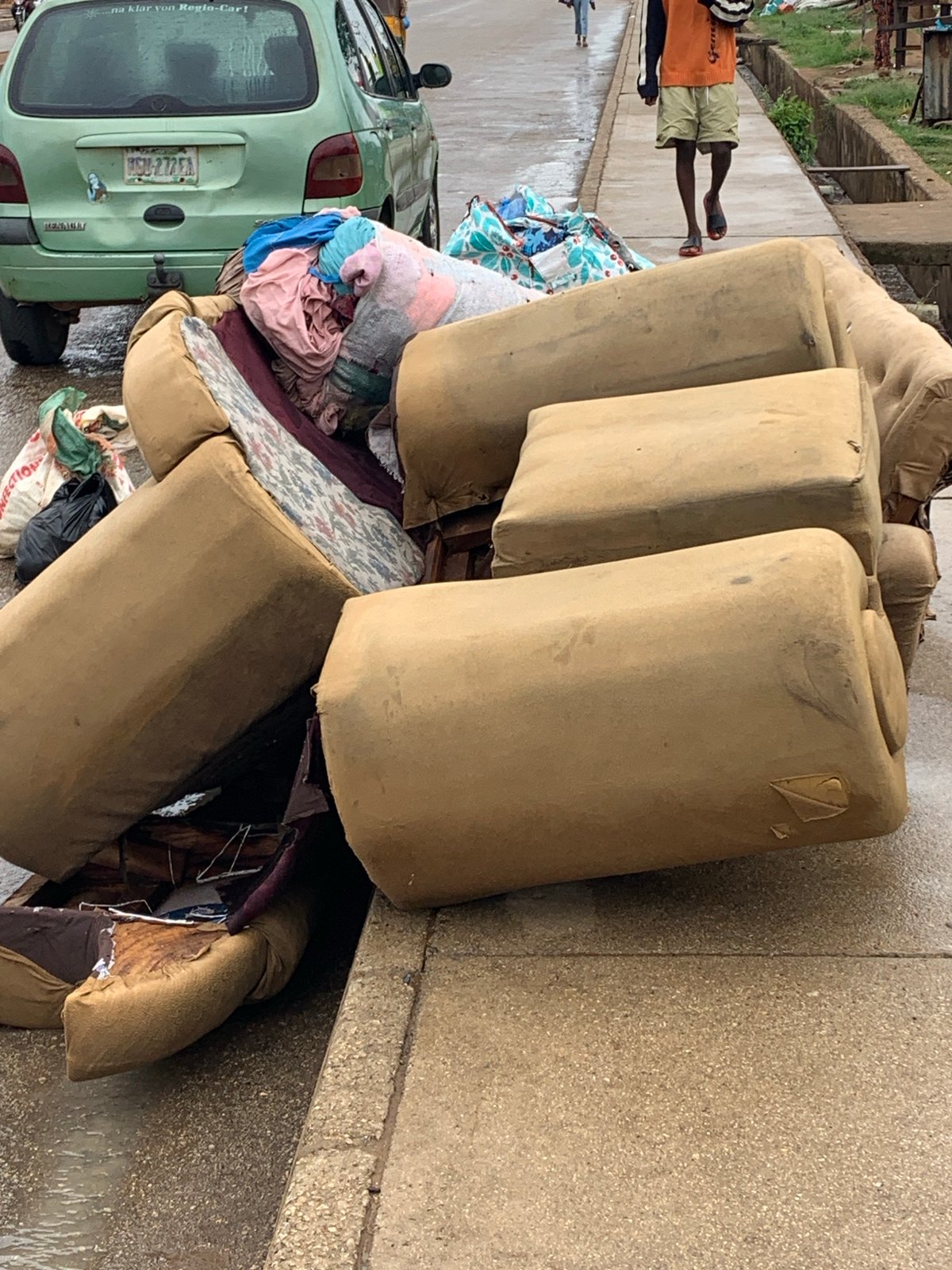Ordinary street life documented across Jos, Nigeria during rainy morning