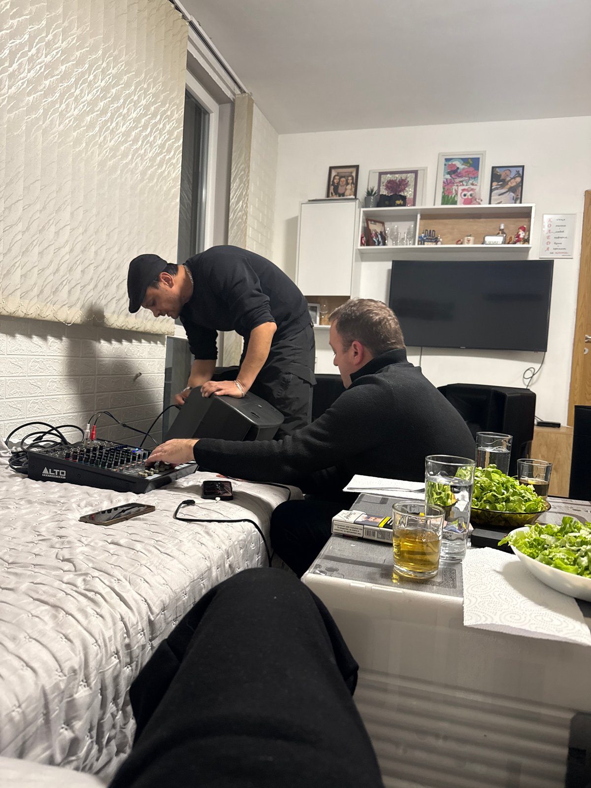 Two men set up DJ equipment at Sofia residence