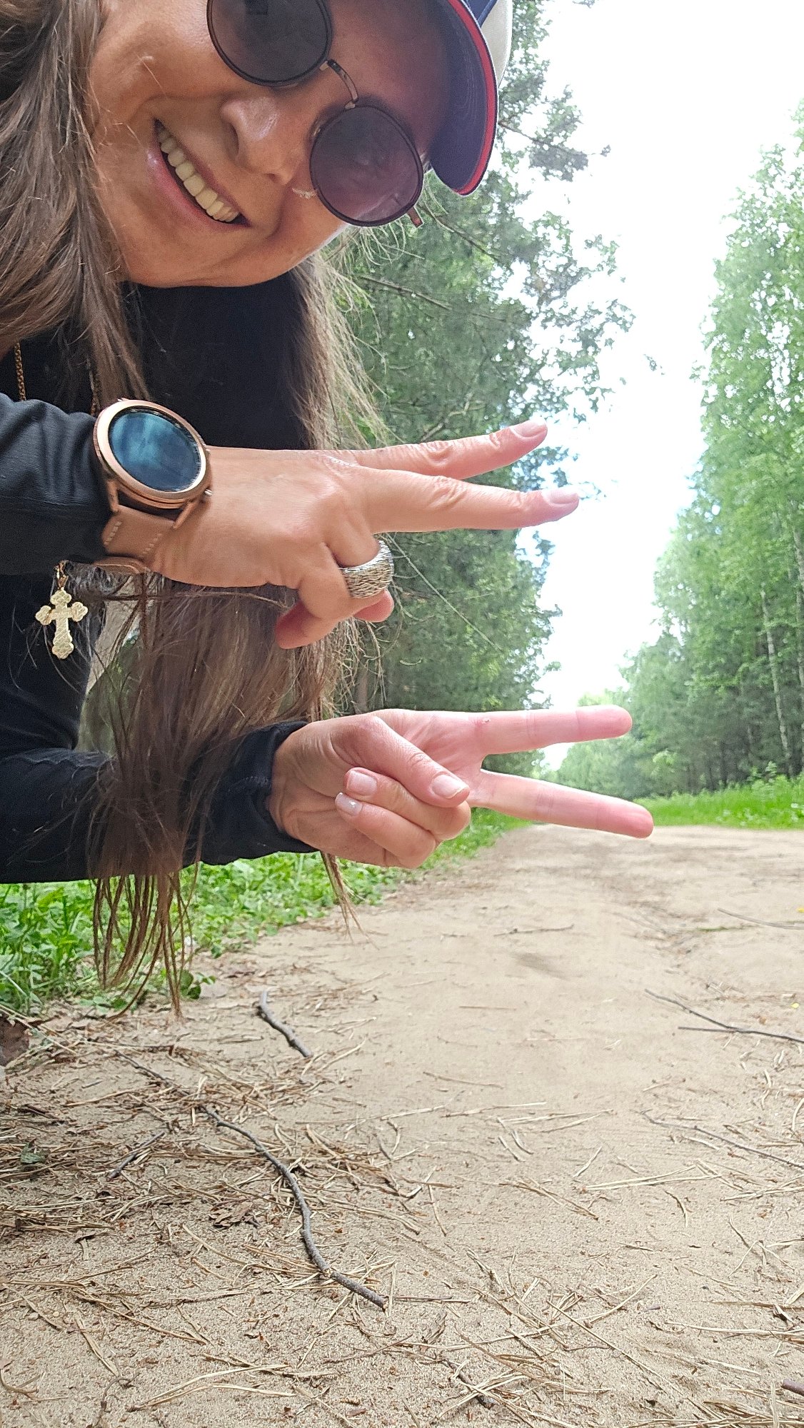 Woman takes outdoor selfies in wooded area near Chaikovsky