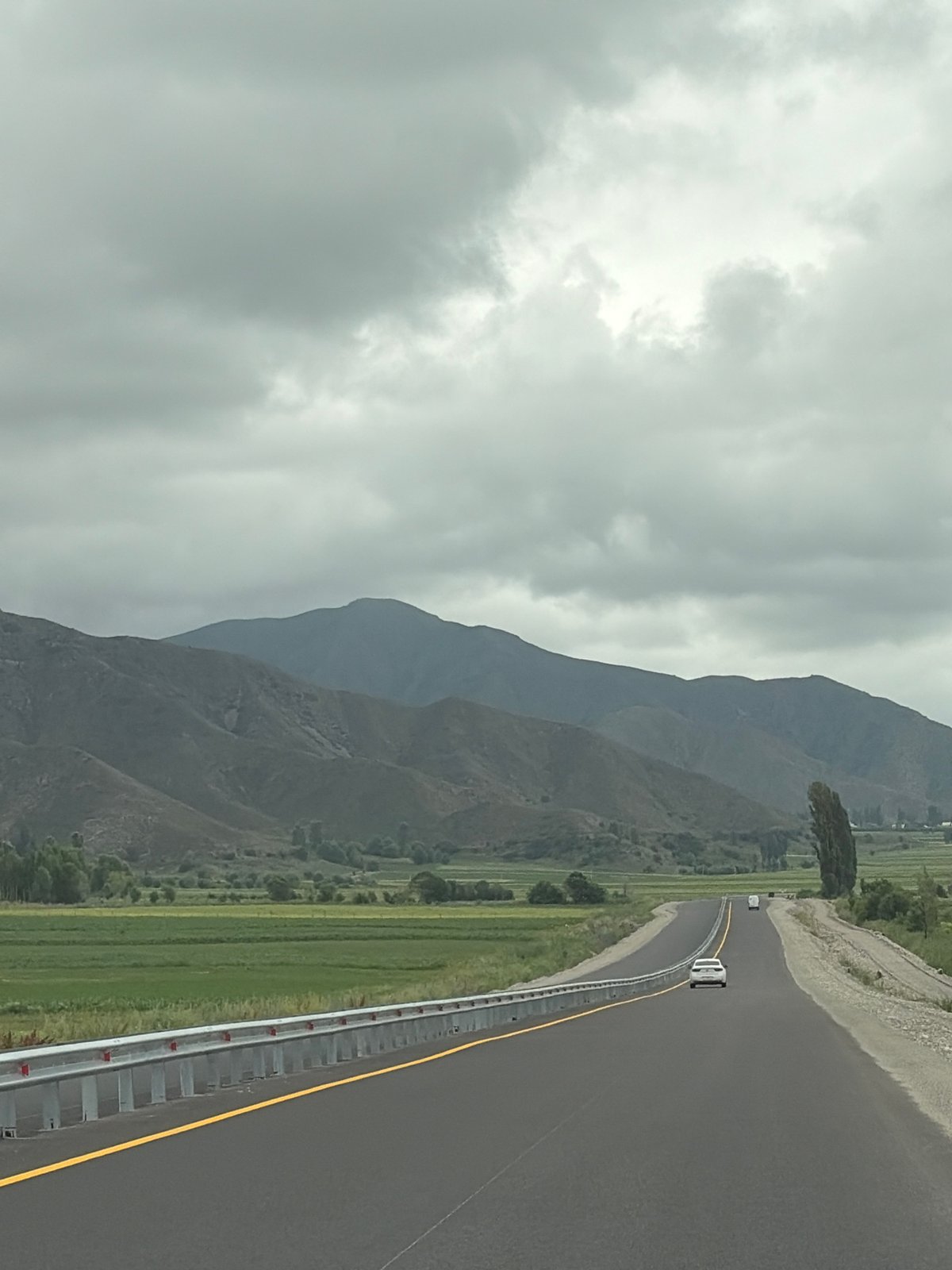 Driving through misty mountain countryside on an overcast morning