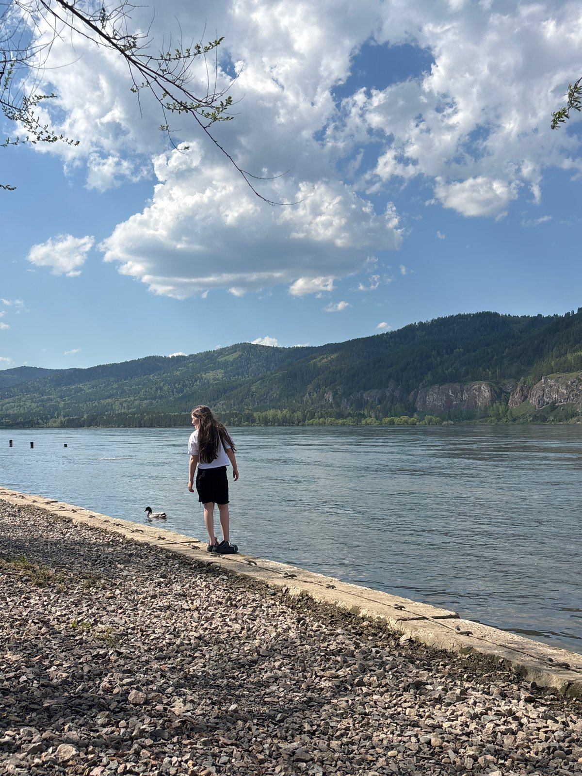 Woman spotted at riverside embankment in Овсянка, Russia