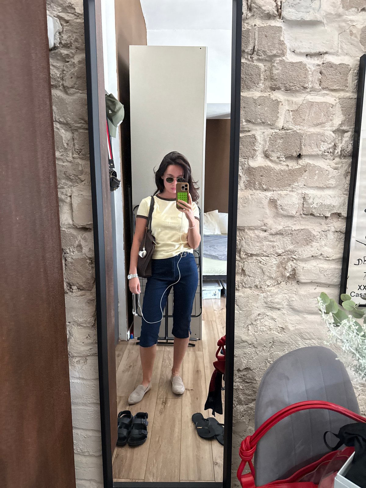 Inside a Tel Aviv loft: mirror selfie and fresh flowers
