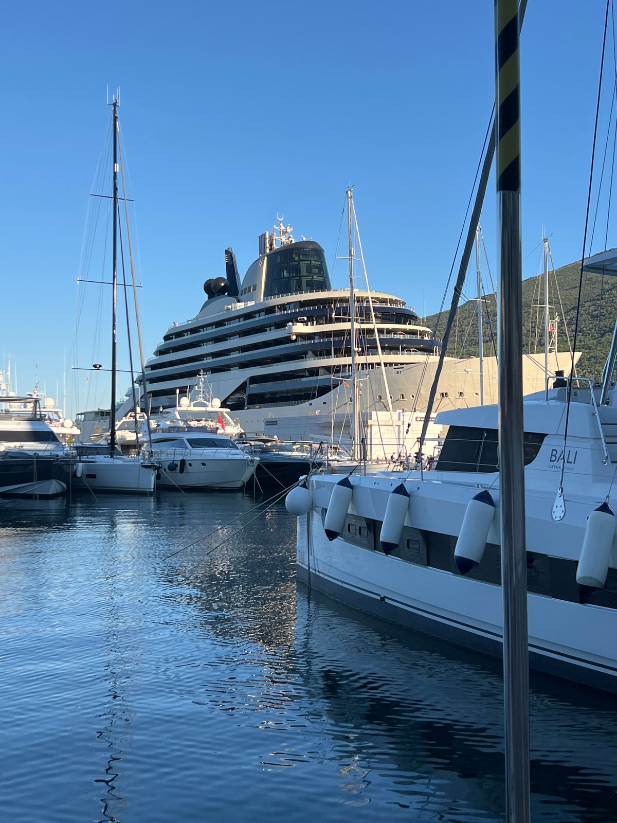 Luxury yachts dock in Montenegro marinas amid casual summer activity