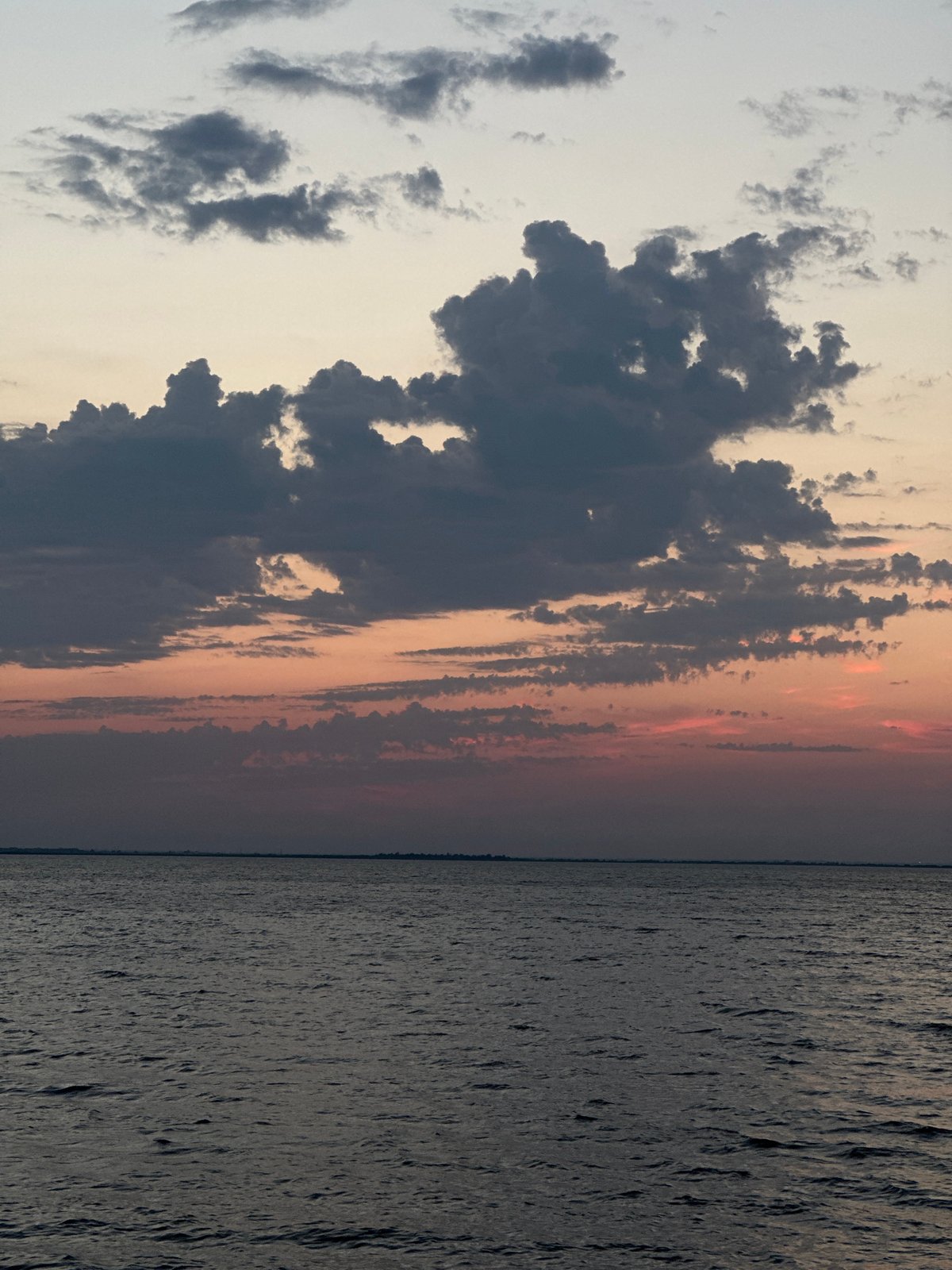 Sunset colors stretch across a calm Kazakhstan seascape