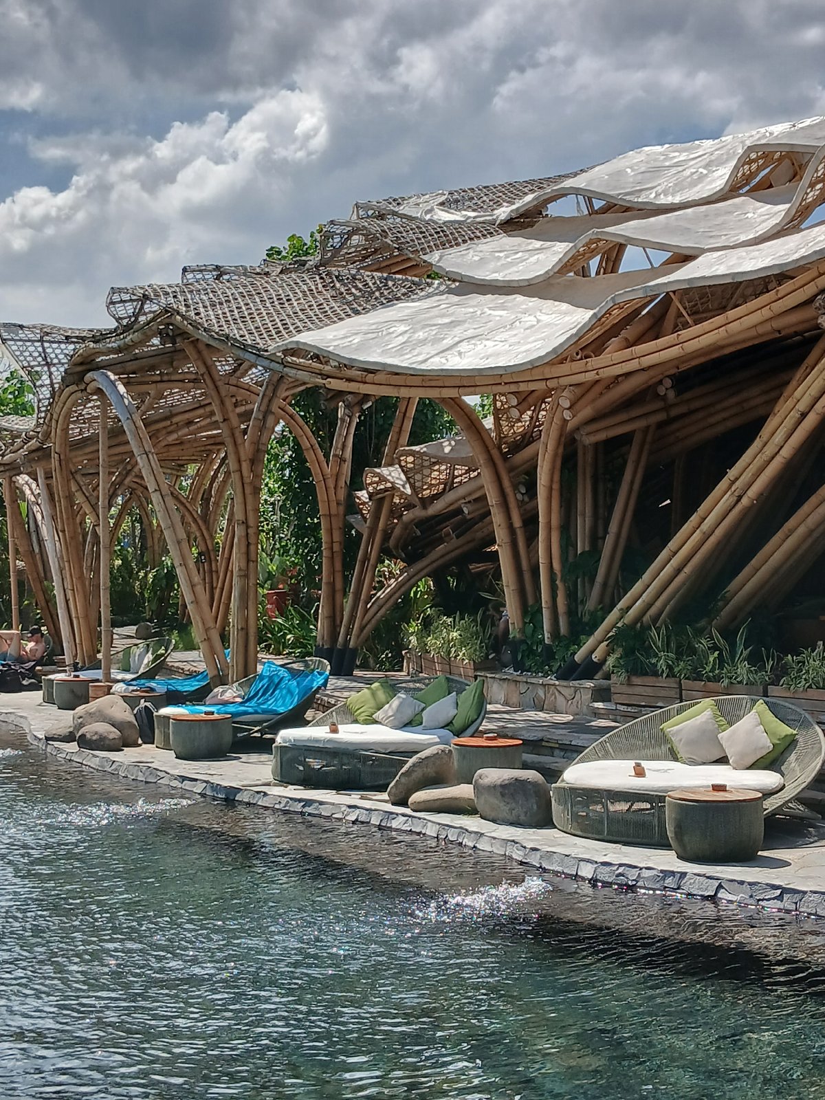 Morning at a coastal Bali resort pool and bamboo restaurant