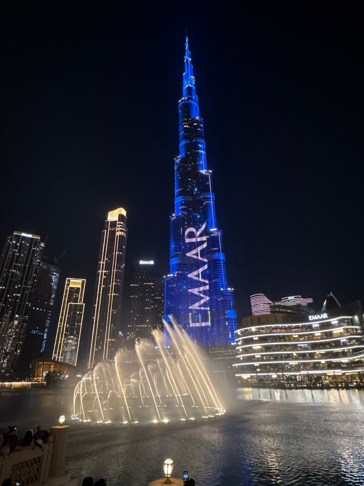 Burj Khalifa displays EMAAR lights during Dubai Fountain show