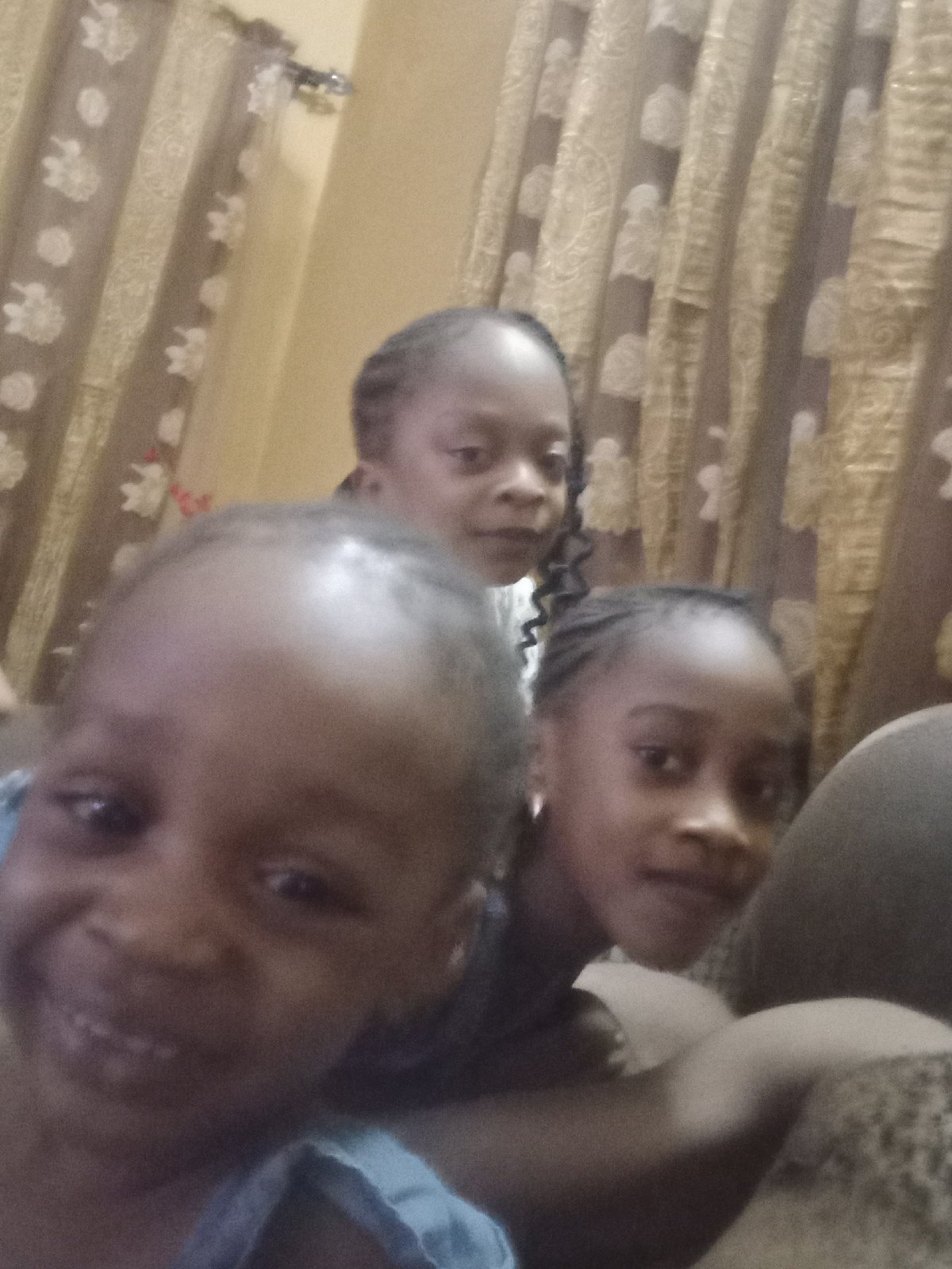 Family poses for photos at home in Nigeria