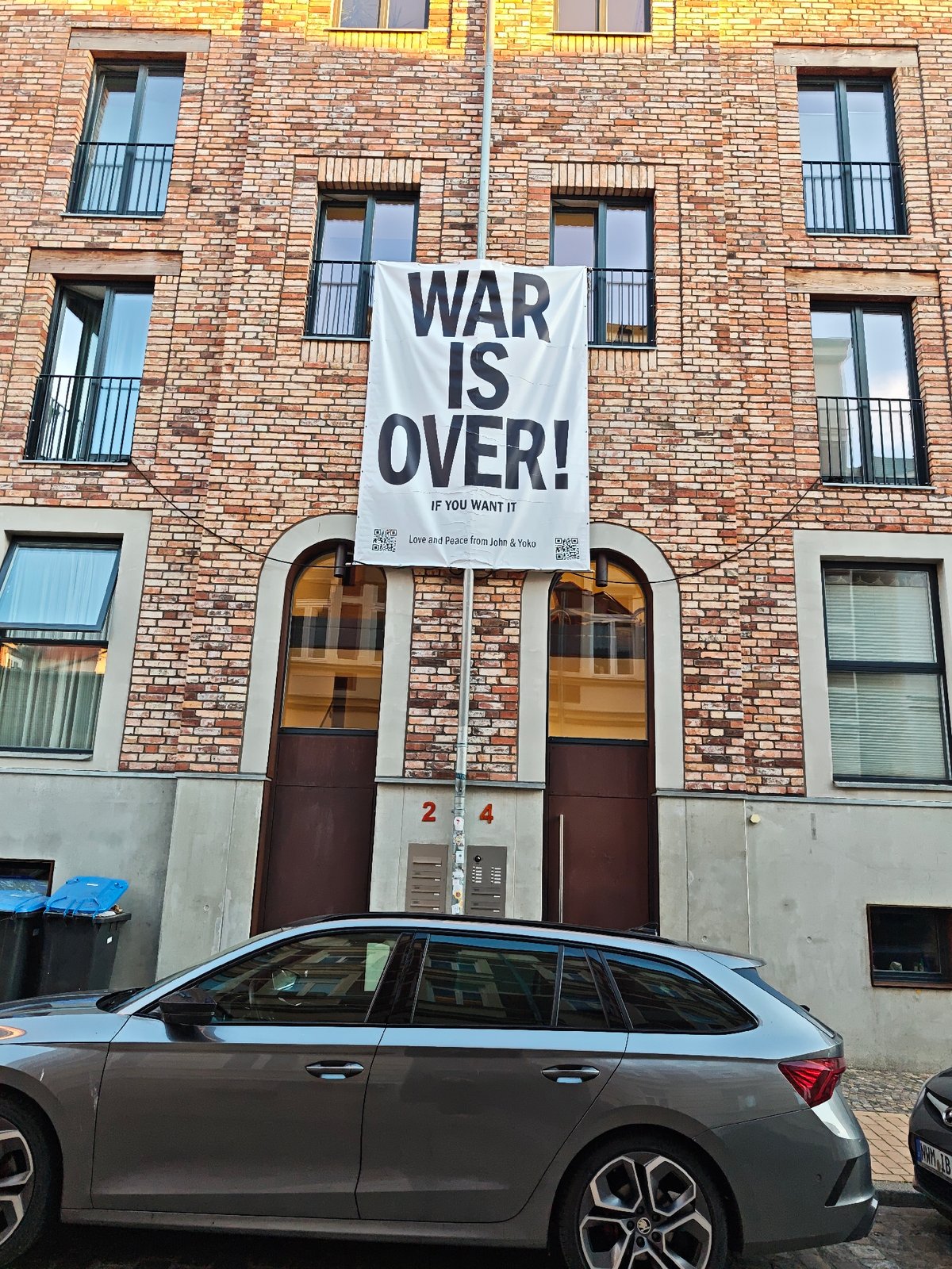 Peace banner and roses on a Schwerin cobblestone street