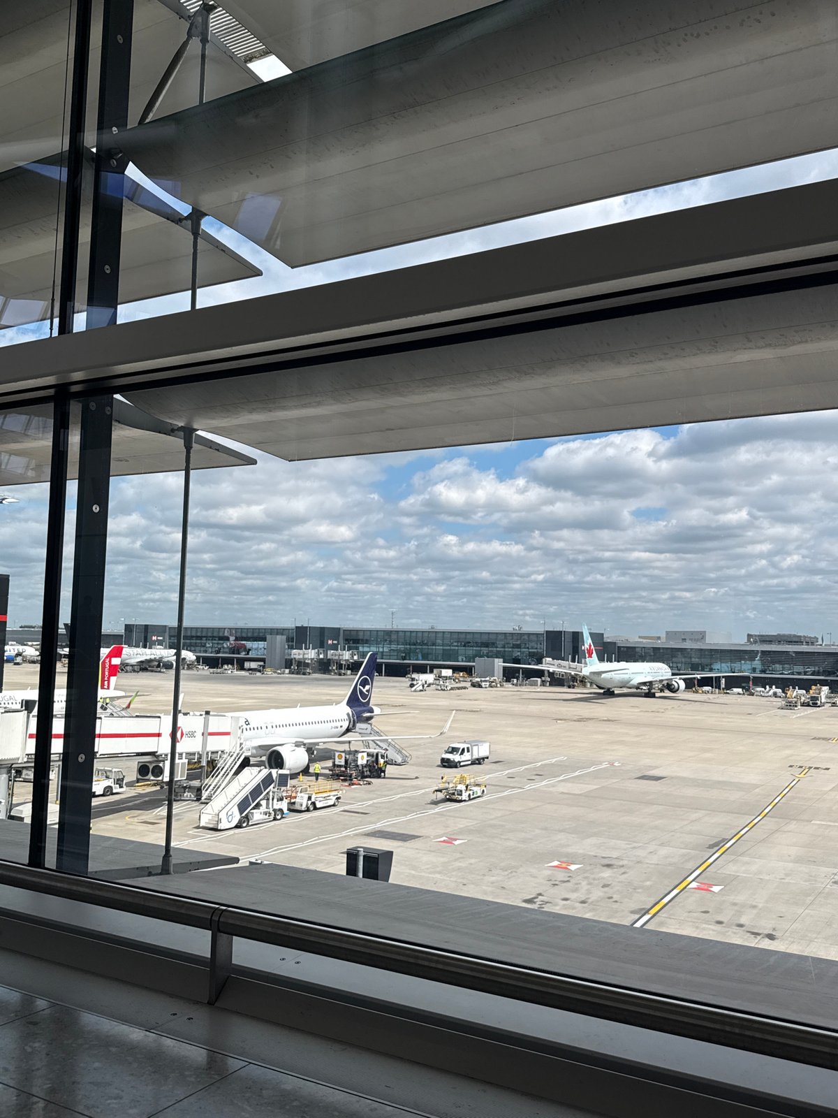 Aircraft visible on London airport tarmac during routine operations
