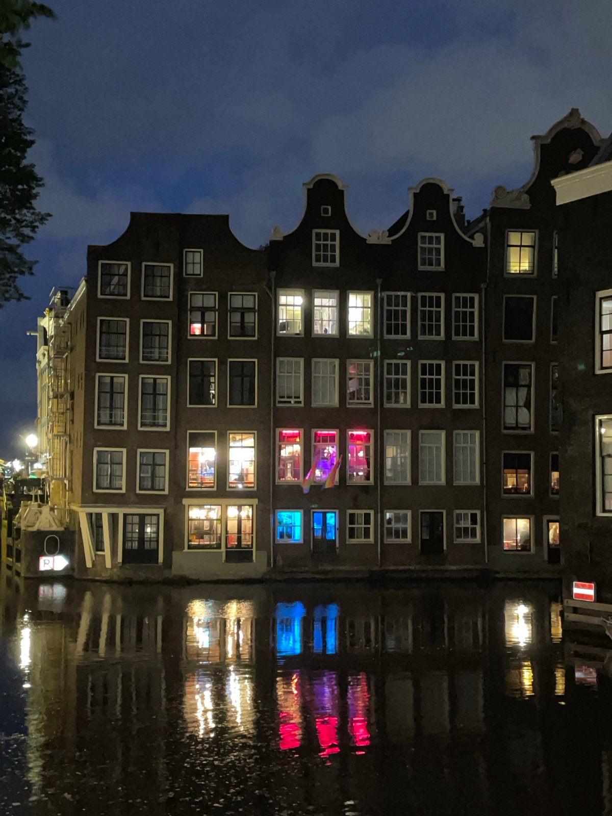 Amsterdam canal houses documented in nighttime scene
