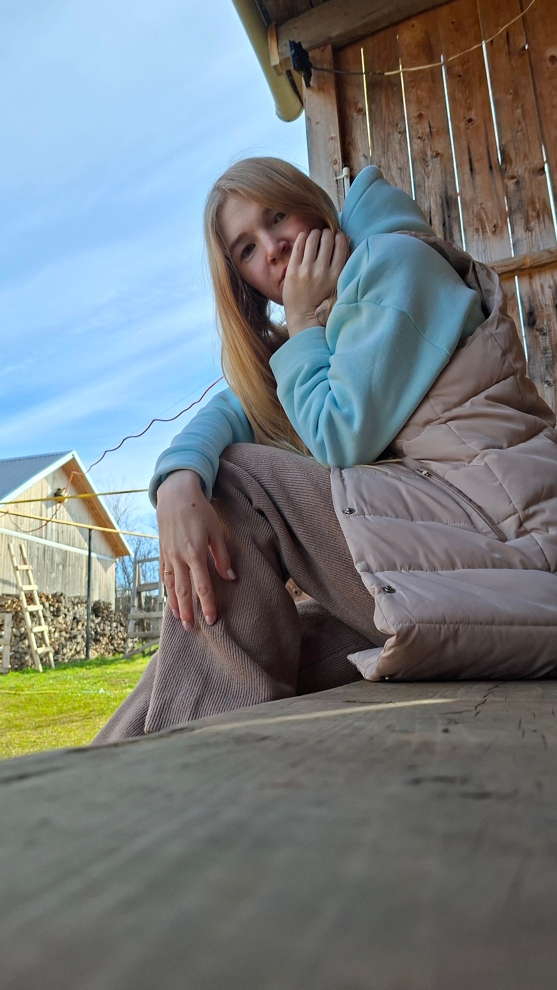 Woman poses for casual photo session in Russian village