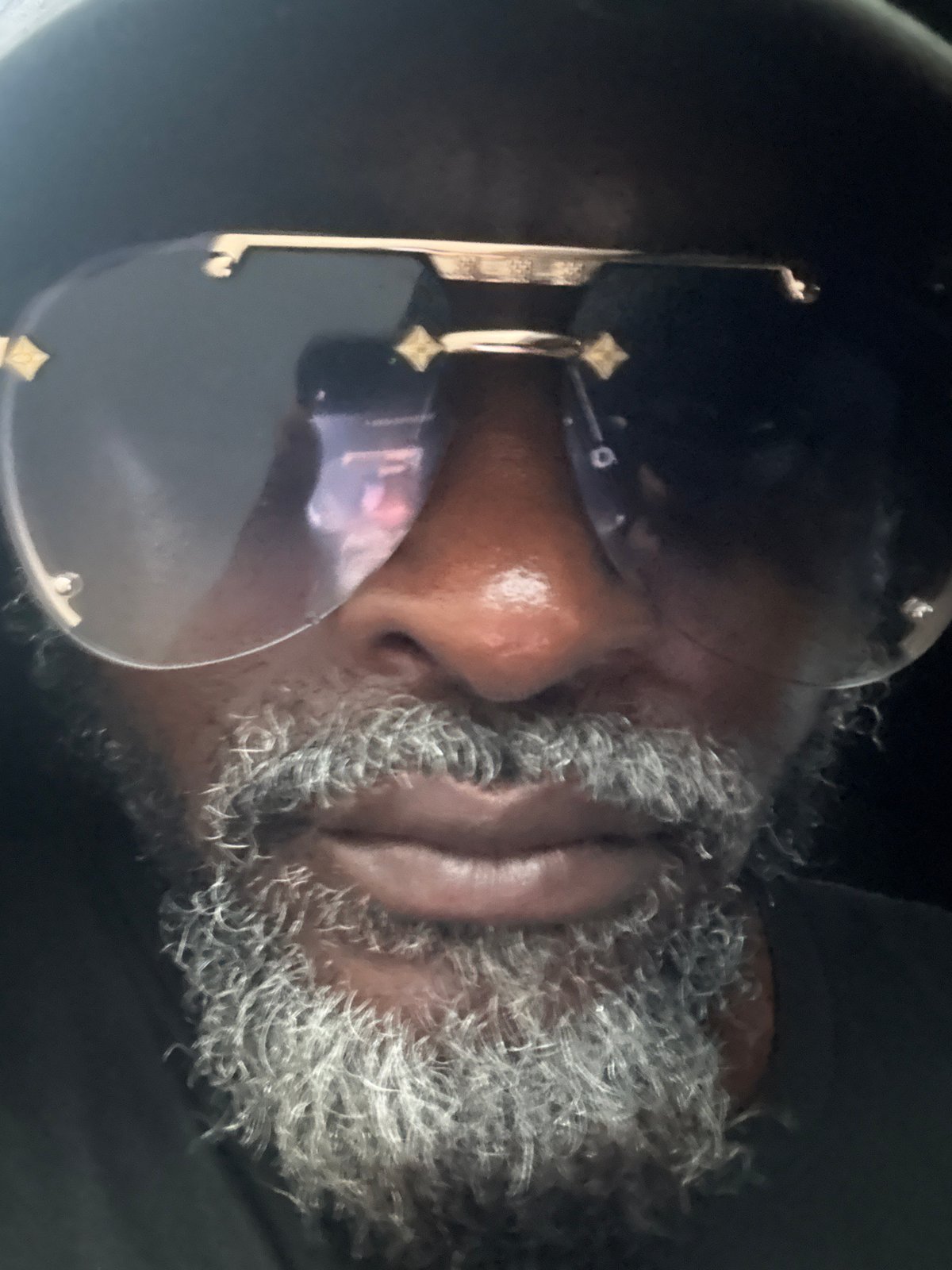 Close-up portrait detail, gold-accent sunglasses, Ado Nigeria