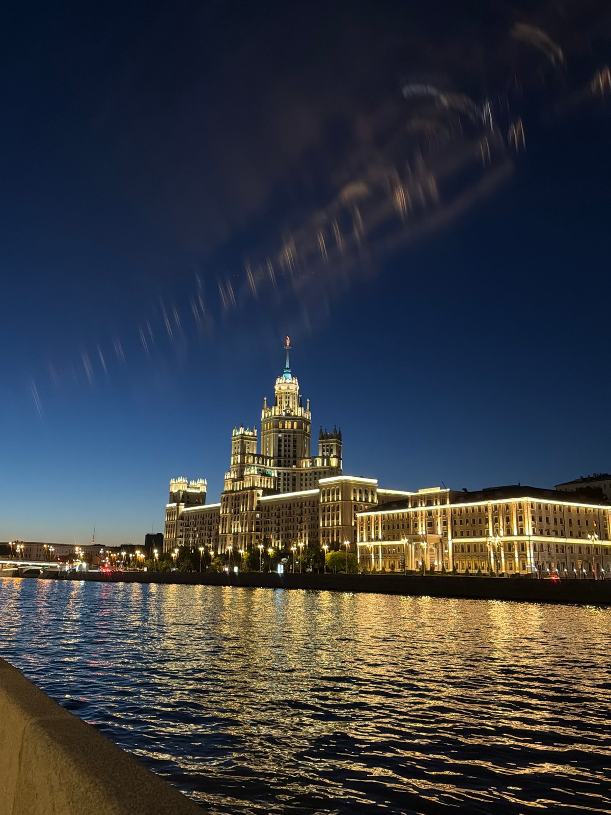 Moscow's Kotelnicheskaya skyscraper glows over the Moskva River at night