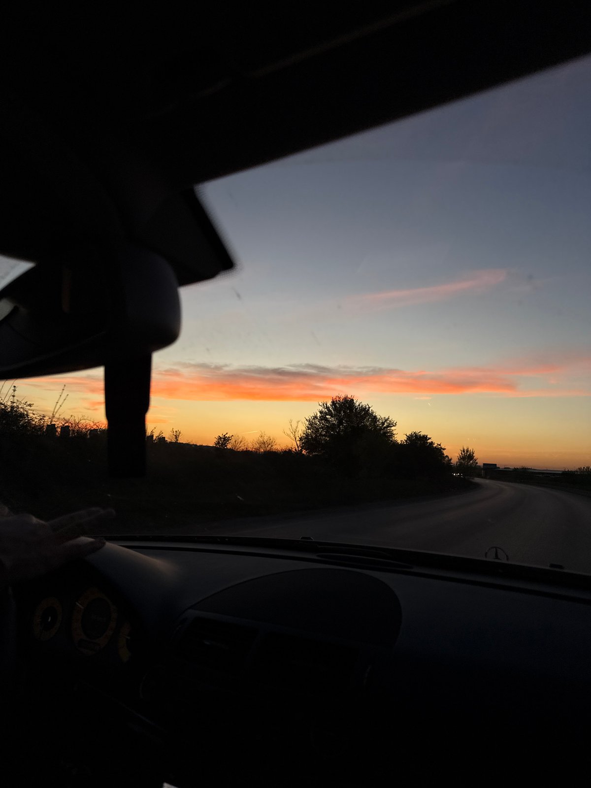 Woman rests in vehicle during sunset in Sofia