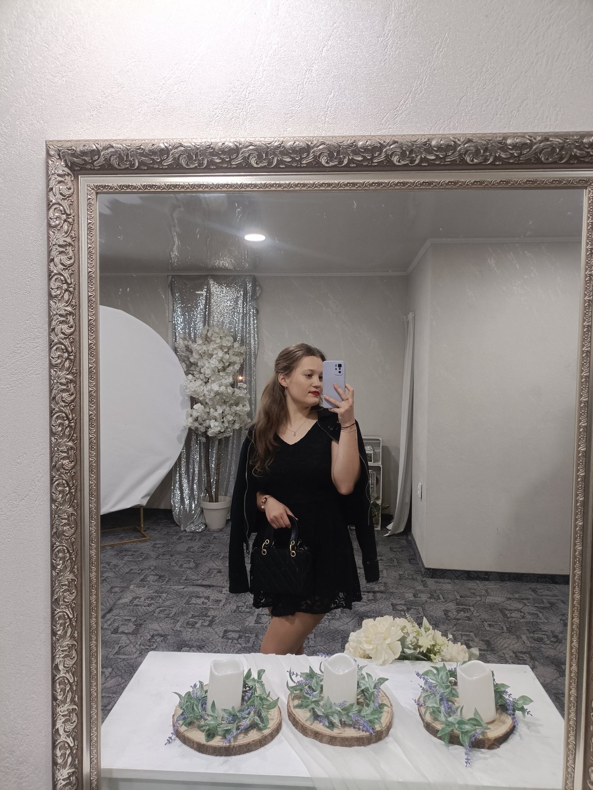 Woman takes mirror selfies at decorated event venue in Plovdiv