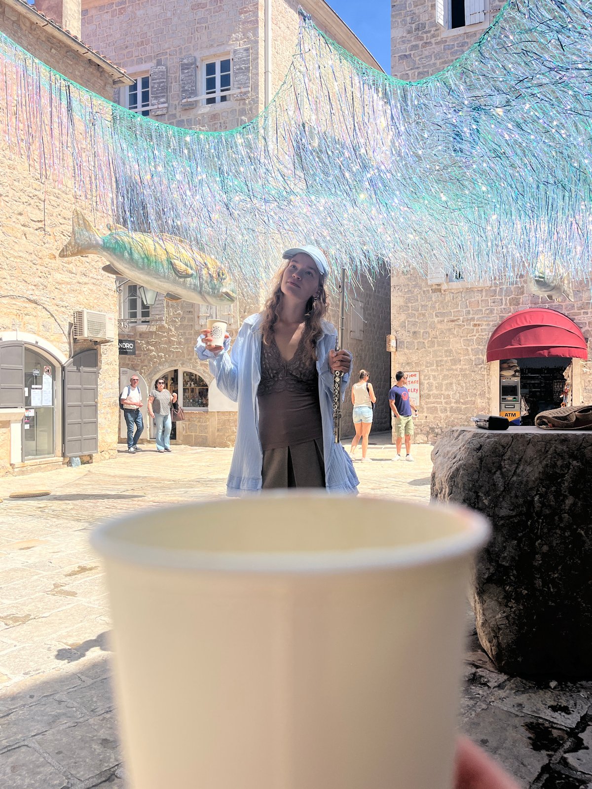 Street musician performs with flute in Budva old town