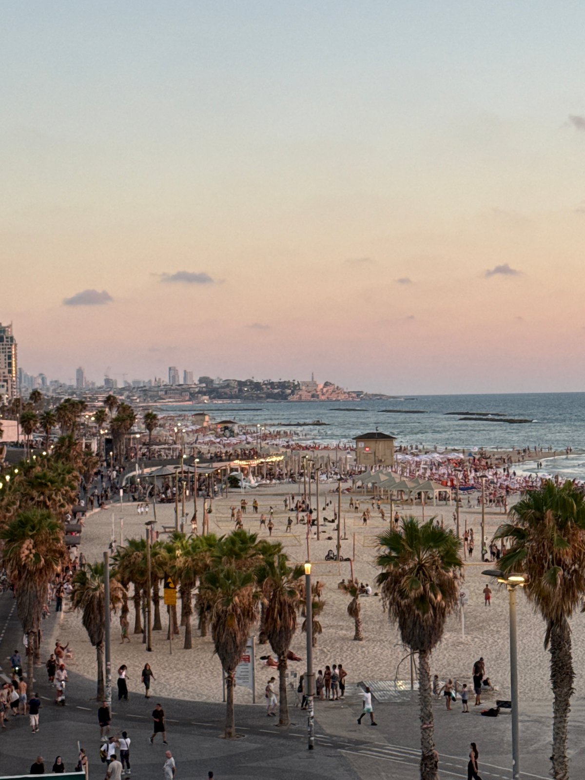 Tel Aviv waterfront at golden hour, beach to marina