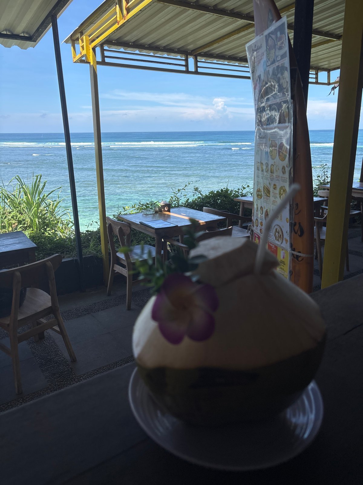 Early morning coconut drink enjoyed at Kuta Selatan beachside cafe