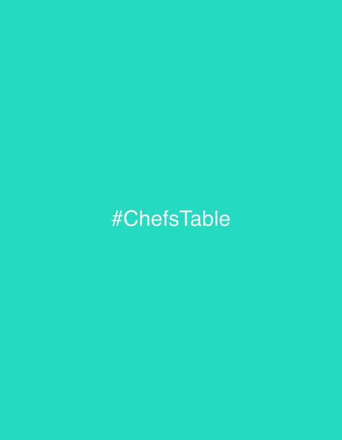 Social media hashtag '#ChefsTable' displayed on teal background