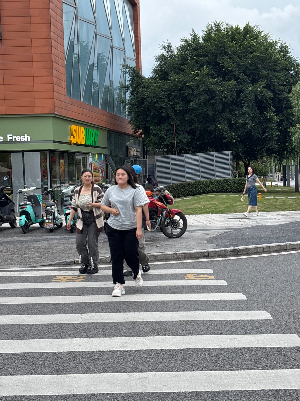 Everyday street life across Liangjiang's commercial district