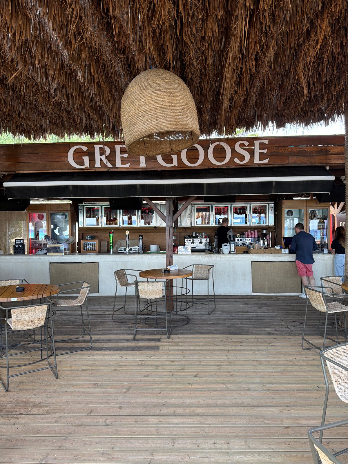 Thatched beach bar and loungers in Nea Peramos, Greece