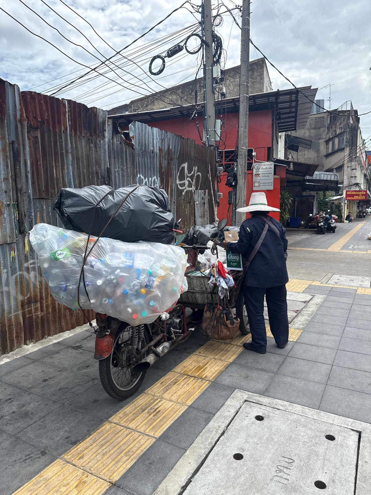 Bangkok street life: traffic, back alleys, and a flag on the sidewalk