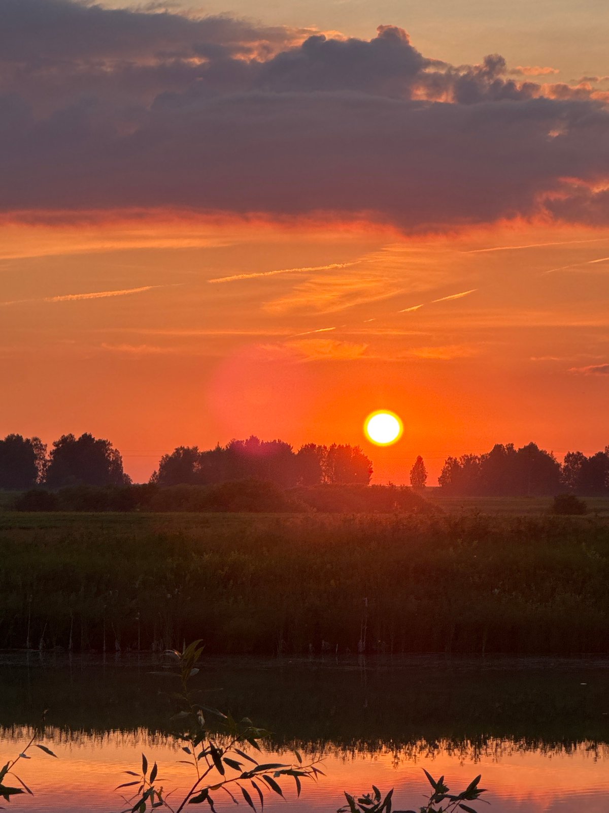 Sunset and crescent moon over the Bigila countryside