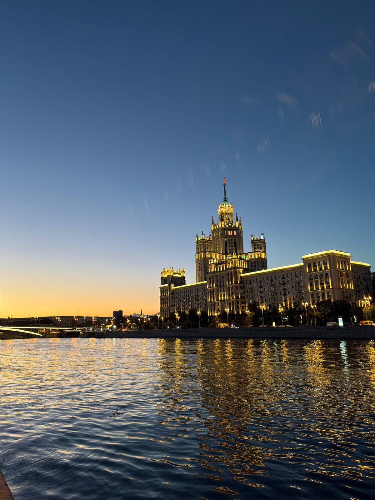 Moscow's Kotelnicheskaya tower at twilight along the Moskva River