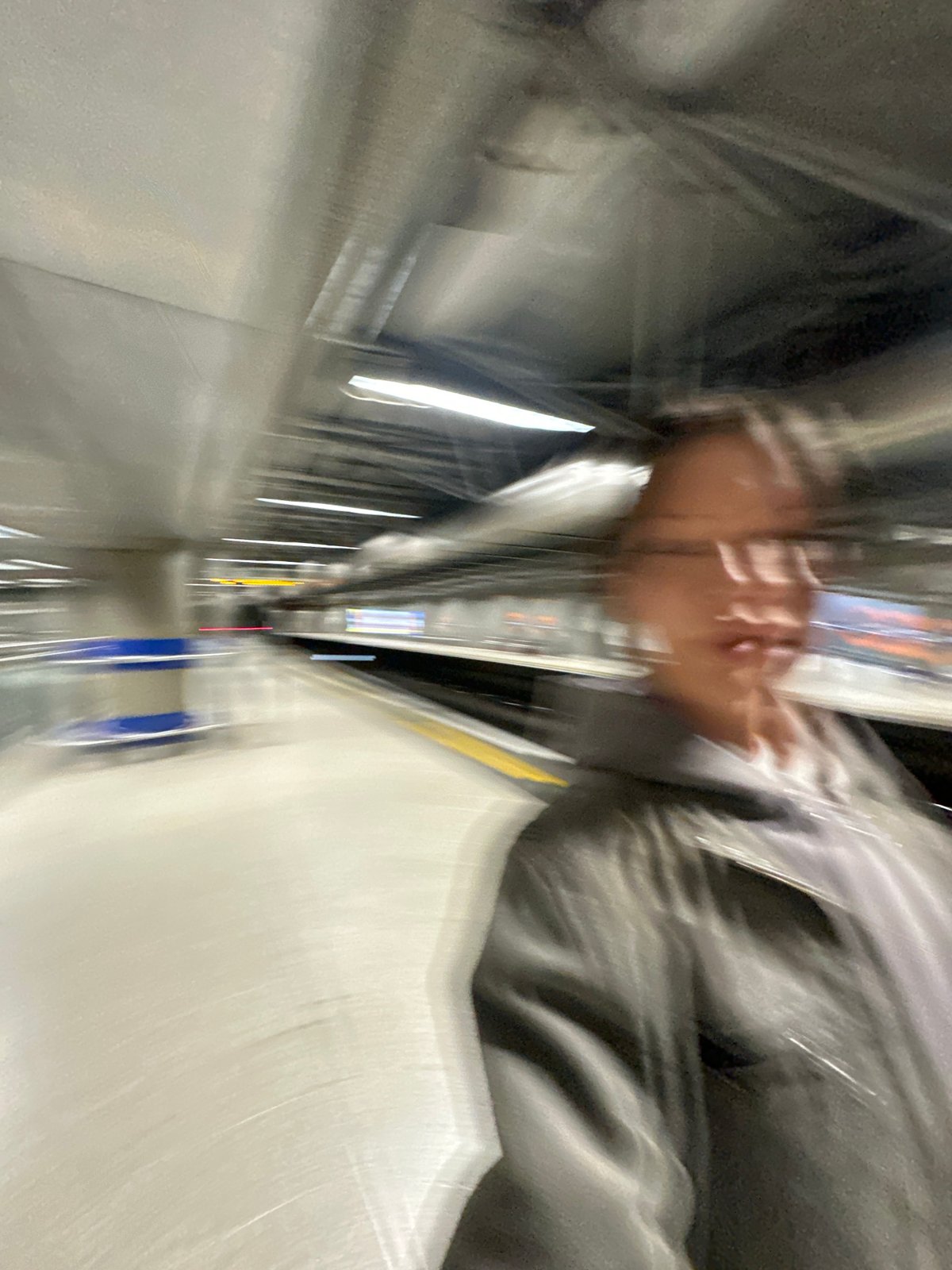 Woman styles hair, takes selfie on London tube platform