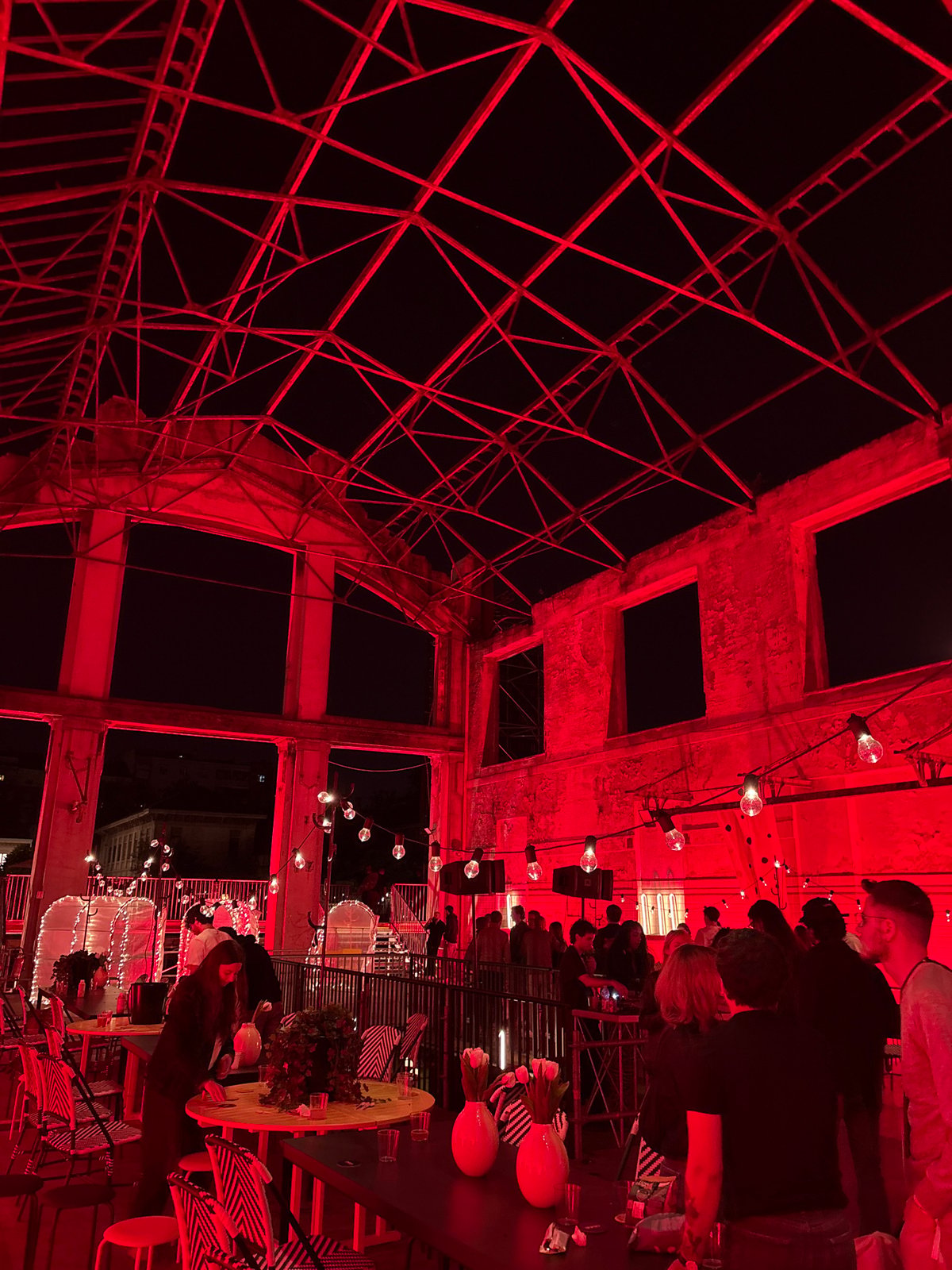 Social gathering at red-lit Milan rooftop bar draws attendees