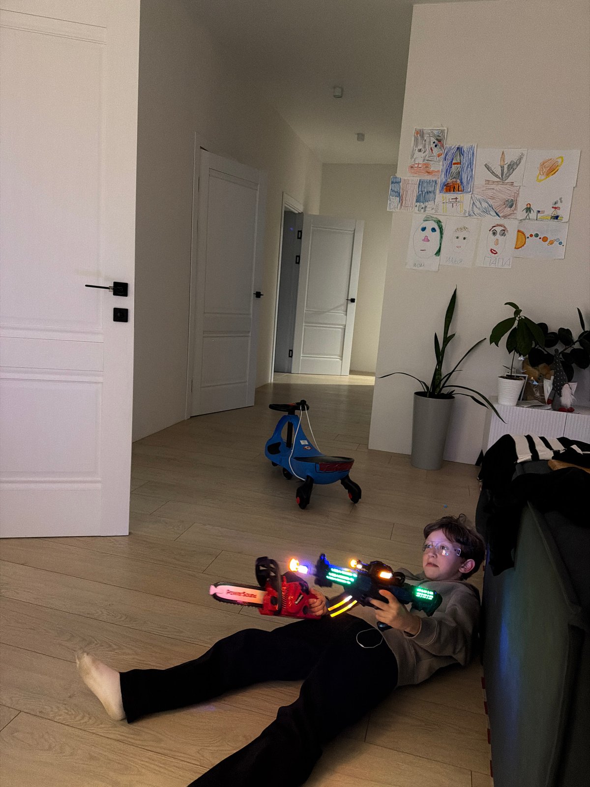 Family playtime captured in Chaikovsky: boy with toys, dog digging