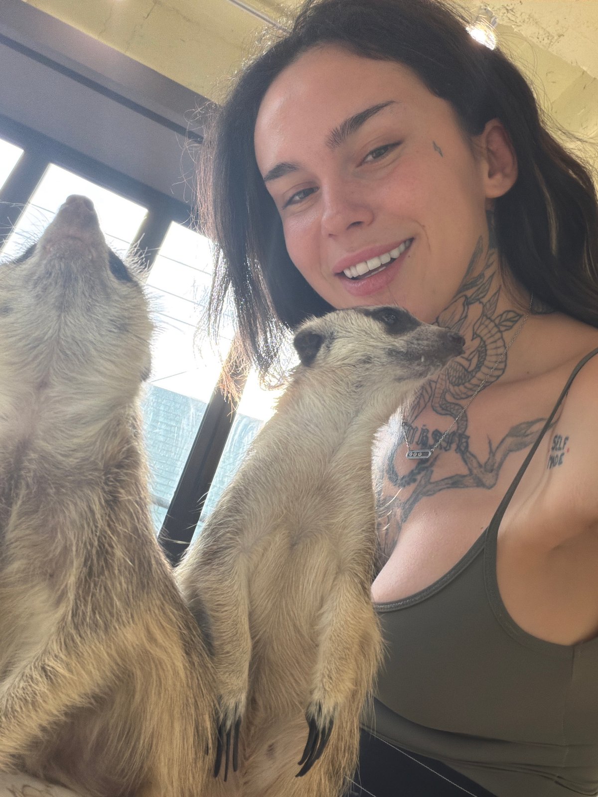 Seoul visitors pose with decorated meerkats at animal facility