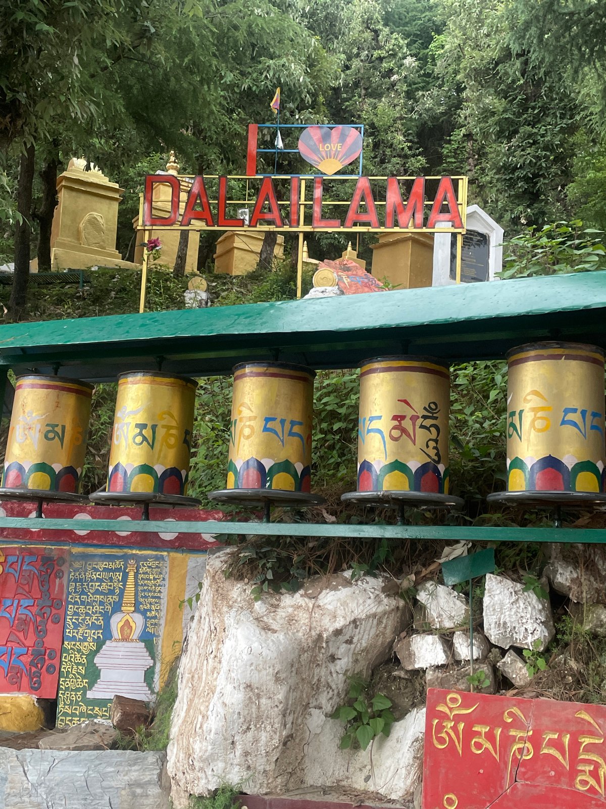Visitor documents Buddhist prayer wheels and Tibetan flags in Dharamshala