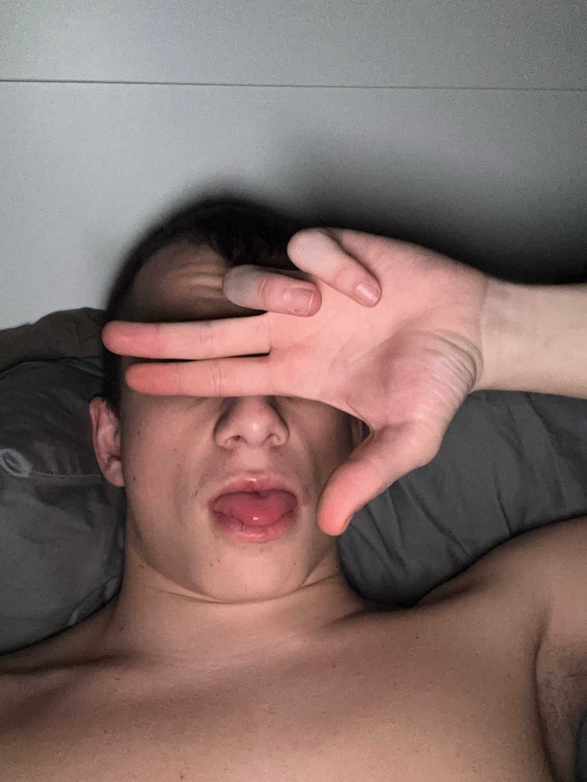 Person photographed resting on bed in Sofia apartment