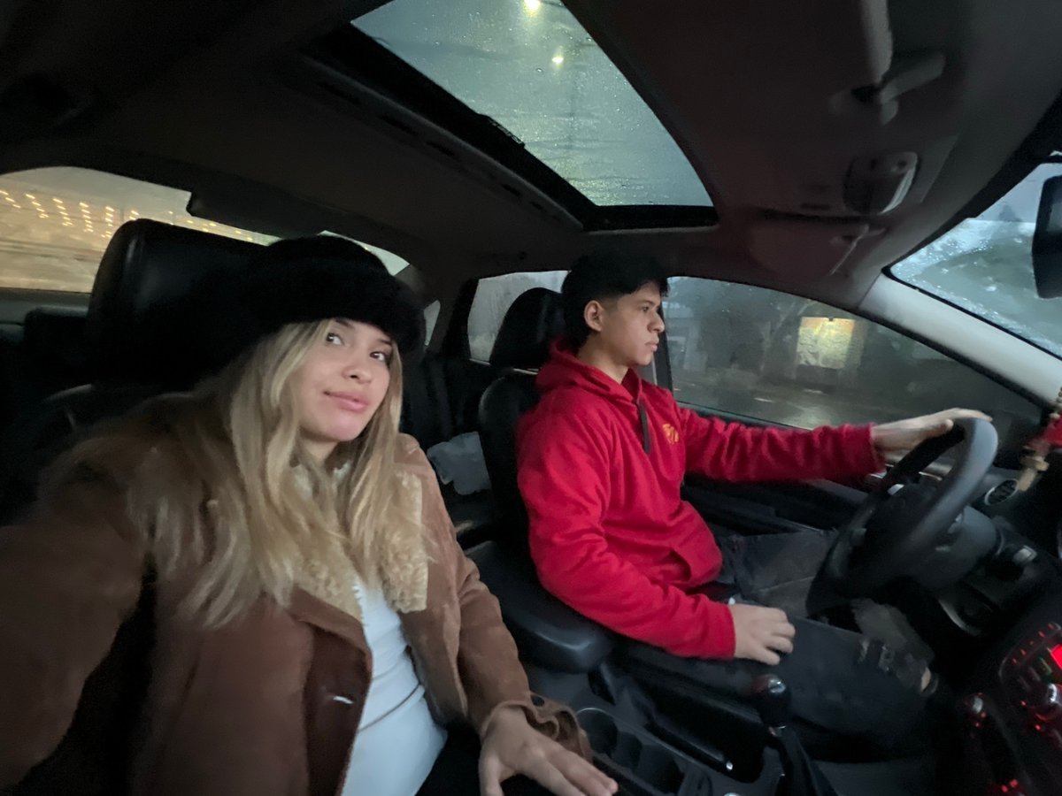 Two people sit in car during rain in Catamarca