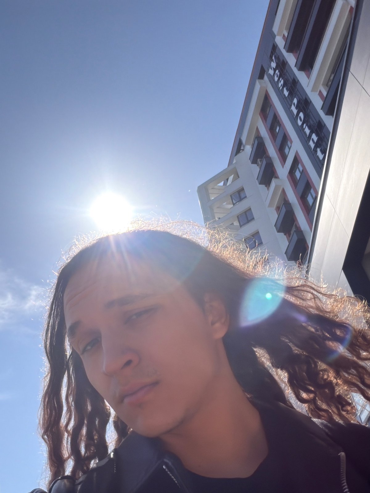 Person photographs self near luxury SUV in Plovdiv