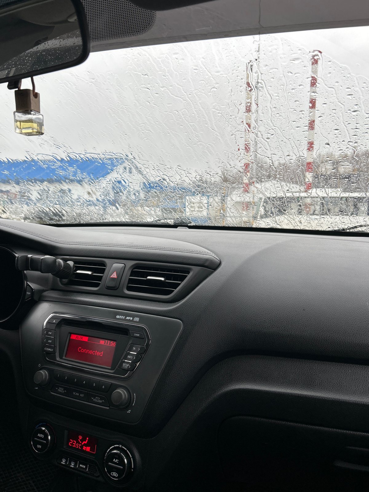 Driver waits in car during rain in Ural'skoe