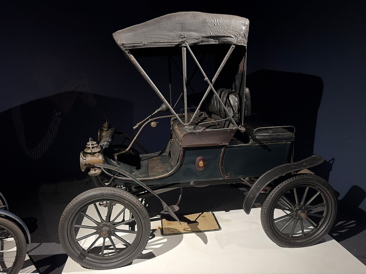 Vintage vehicle collection displayed at museum exhibition hall