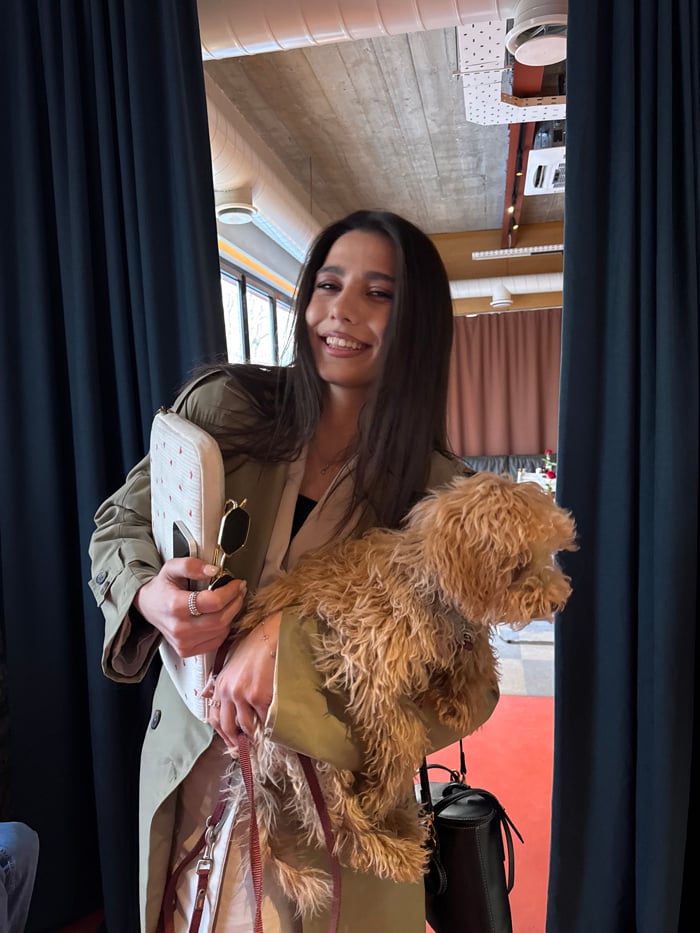Woman walks small dog through downtown Yerevan cafes and park