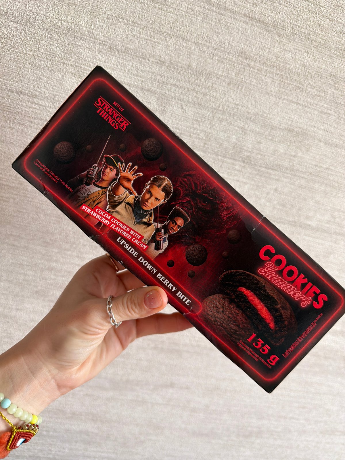 Person in Khimki handles themed merchandise, watches video content
