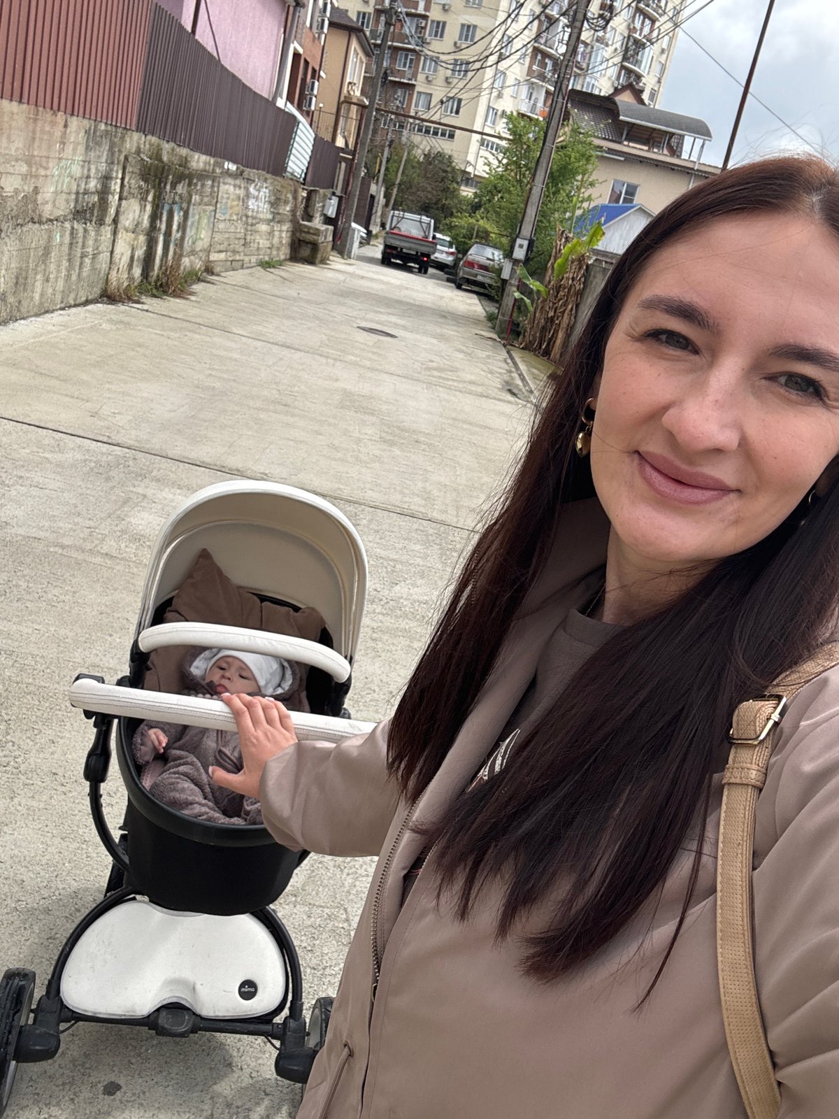 Mother with baby and dog takes morning stroll through Sochi