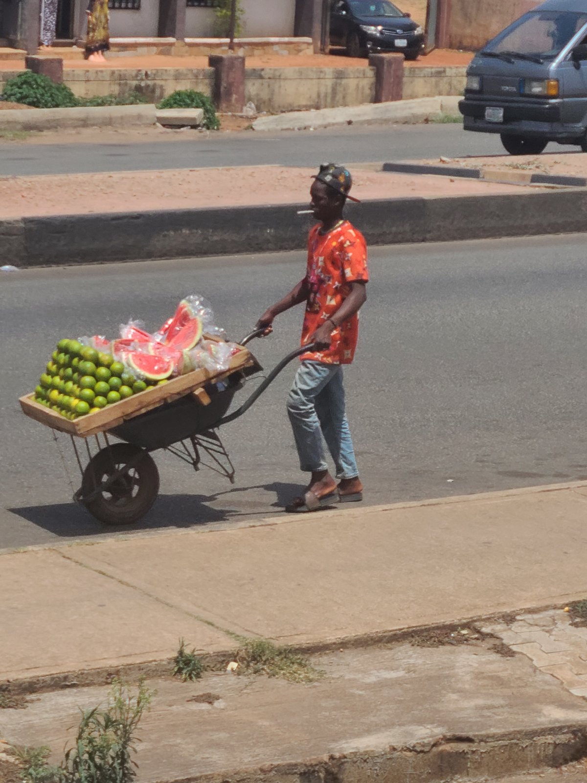 Daily life unfolds across sunny Jos streets