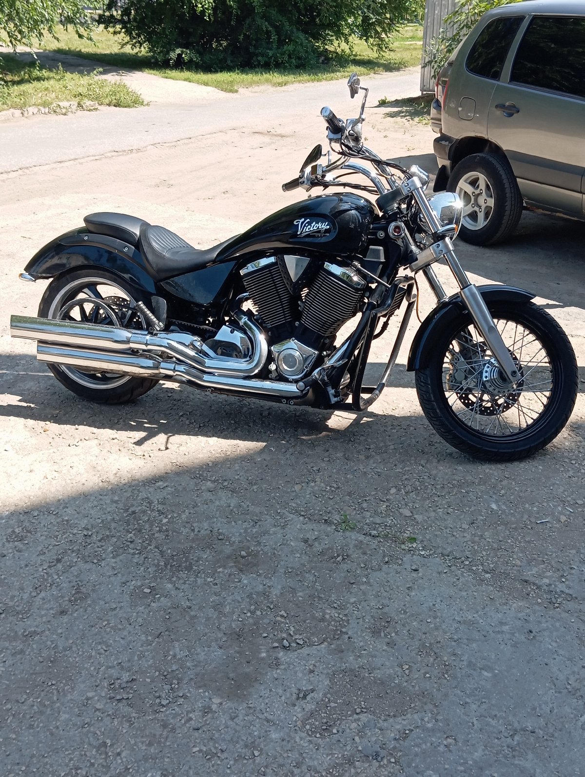 Black Victory motorcycle parked on gravel in Balakovo