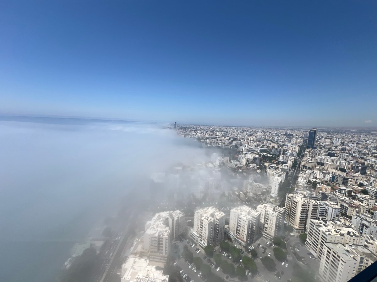 Morning fog rolls over Limassol's coastline from above
