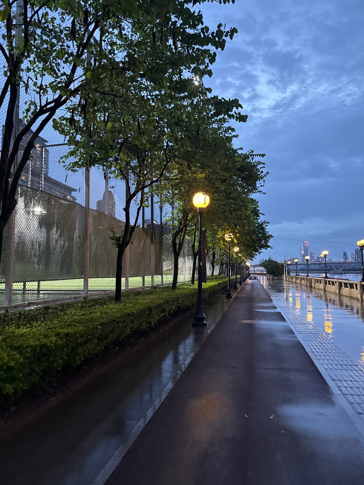 Rainy dusk along Haizhu's Pearl River waterfront promenade